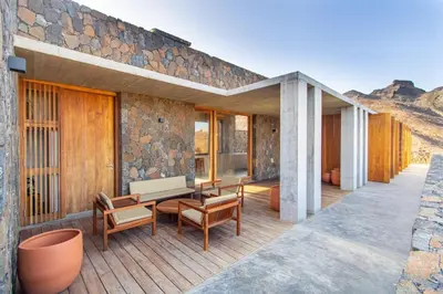 a patio with a table and chairs on a building at Villa, Vue Mer et Piscine Privée in Mindelo