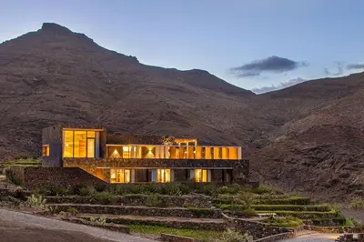 a house in the middle of a mountain at Villa, Vue Mer et Piscine Privée in Mindelo