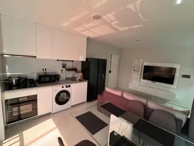 a living room with a couch and a kitchen at Alojamento Ribeirinha in Mindelo
