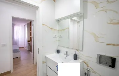 a bathroom with a sink and a mirror at Rita Apartamento in Mindelo