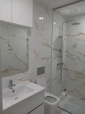 a bathroom with a shower and a toilet and a sink at Rita Apartamento in Mindelo