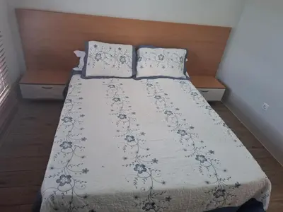 a bed with two pillows on top of it at Brisa Mar Apartamento in Praia Baixo