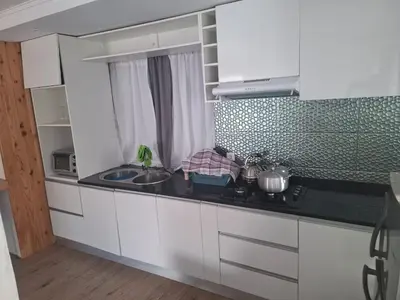 a kitchen with a sink and a counter top at Brisa Mar Apartamento in Praia Baixo