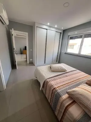 a bedroom with a large bed and a window at LAGINHA Apartamento in Mindelo