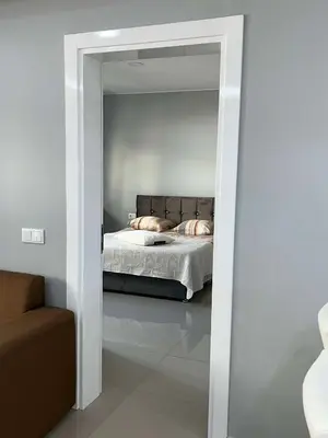 a bedroom with a bed in a white room at LAGINHA Apartamento in Mindelo