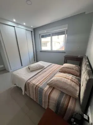 a large bed in a bedroom with a window at LAGINHA Apartamento in Mindelo