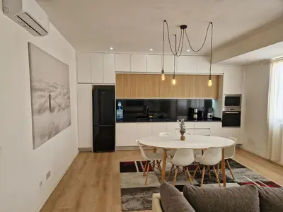 a kitchen and dining room with a table and chairs at Sunset in Mindelo