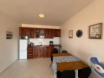 a kitchen with a table and a white refrigerator at Blue Ocean Escapes in Santa Maria