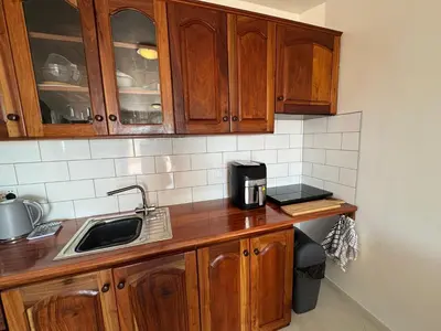 a kitchen with wooden cabinets and a sink at Blue Ocean Escapes in Santa Maria