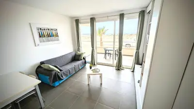 a living room with a couch and a view of the ocean at Turtle Apart in Sal Rei