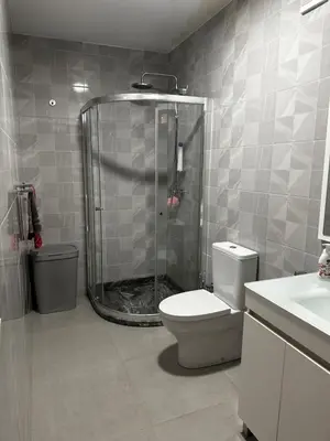 a bathroom with a shower and a toilet at Fanon Flat T2 in Mindelo