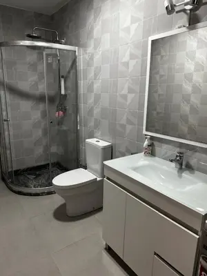 a bathroom with a shower and a toilet and a sink at Fanon Flat T2 in Mindelo