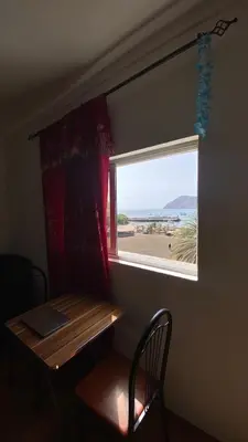 a table and a window in a room with a table and a chair at Tarrafal Paradise Suite in Tarrafal