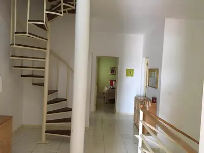 a hallway with a spiral staircase in a house at Espaço 3M in Praia