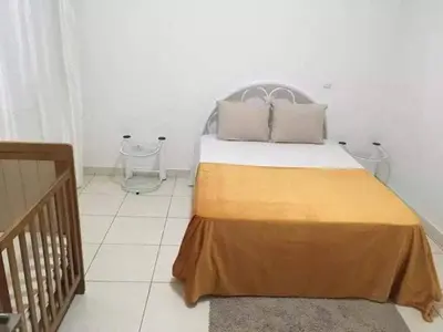 a bedroom with a bed and a crib at Espaço 3M in Praia