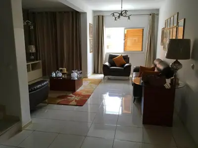 a living room with a couch and a table at Espaço 3M in Praia