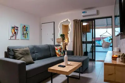 a living room with a blue couch and a table at Tropical Suite 22 A in Santa Maria