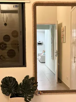 a mirror reflecting a hallway in a living room at Tropical Suite 22 B in Santa Maria