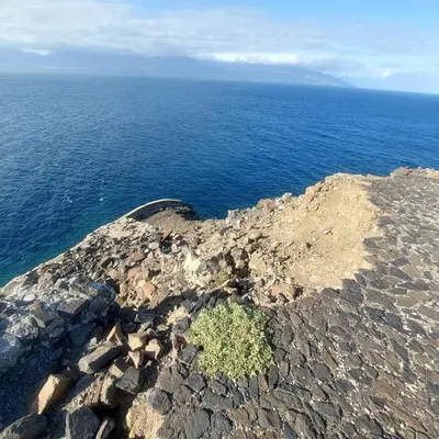 an island in the ocean with a small plant on it at Oia Mindelo Chambre d'hotes in Mindelo