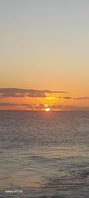 a sunset over the ocean with the sun setting at Oia Mindelo Chambre d'hotes in Mindelo