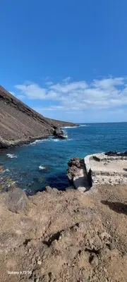 a view of the ocean from a rocky beach at Oia Mindelo Chambre d'hotes in Mindelo