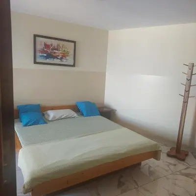 a bedroom with a bed with blue pillows at Oia Mindelo Chambre d'hotes in Mindelo