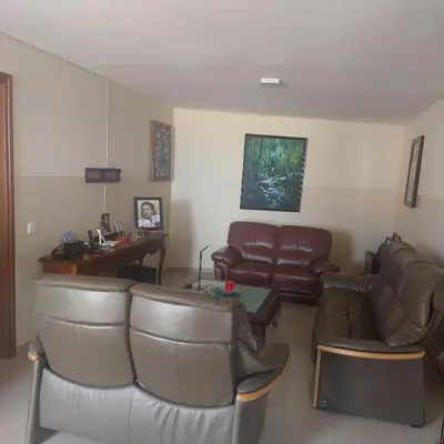 a living room with leather furniture and a desk at Oia Mindelo Chambre d'hotes in Mindelo