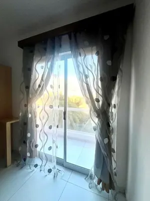 a window with a curtain in a room at Oásis de retour in Ponta do Sol