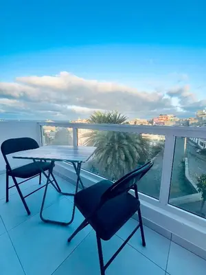 a table and chairs on a balcony with a view at Oásis de retour in Ponta do Sol
