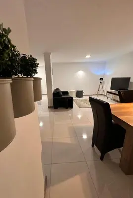 a living room with a table and chairs at Duarte Apartments - Império in Mindelo