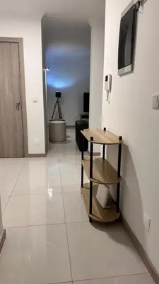 a hallway with a table and a room with a door at Duarte Apartments - Império in Mindelo