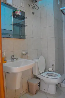 a bathroom with a toilet and a sink at Suíte Salinas - Vila Cabral 2 in Sal Rei