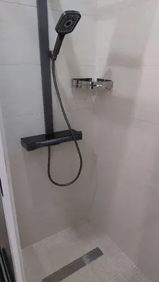 a shower with a shower head in a bathroom at Lily holiday hotel in Mindelo