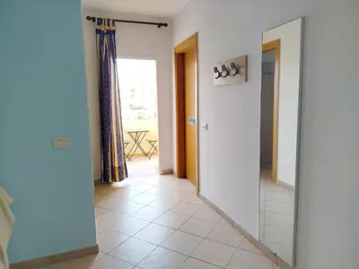 a hallway with a mirror and a door to a room at Onda do Mar in Santa Maria
