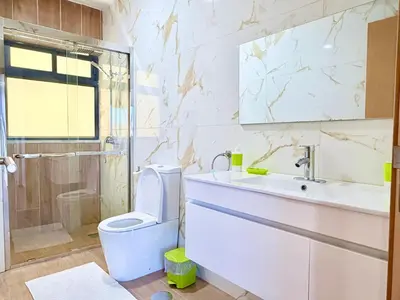 a bathroom with a toilet and a sink and a shower at My Home CV in Praia