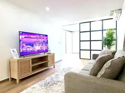 a living room with a tv and a couch at My Home CV in Praia