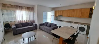 a kitchen and living room with a couch and a table at Maravilha do Planalto in Assomada