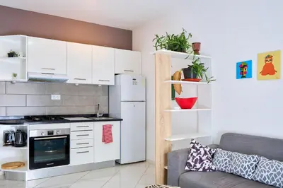 a kitchen with a white refrigerator and a couch at Super Cozy One-Bedroom Apartment in Santa Maria