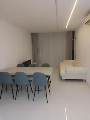 a room with a table and chairs and a couch at T1 da Marília fonte frances , terceiro piso a esquerda in Mindelo