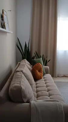 a bed with pillows on it in a room at Apartamento em Praia - Palmarejo in Praia