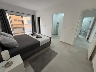 a bedroom with a bed and a large window at Urban Mindelo in Mindelo