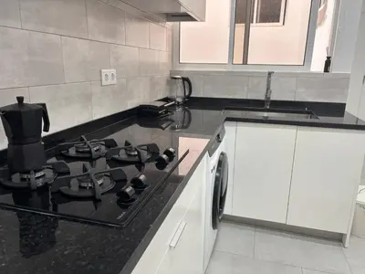 a kitchen with a stove top oven in a kitchen at Urban Mindelo in Mindelo