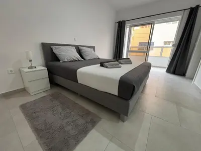 a bedroom with a bed and a large window at Urban Mindelo in Mindelo