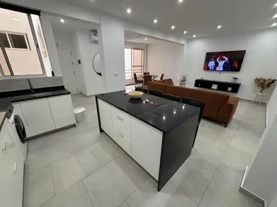 a large living room with a kitchen and a living room at Urban Mindelo in Mindelo