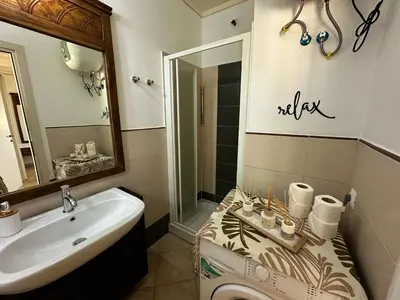 a bathroom with a sink and a toilet at Tropical Pool View - By Bobbywashere in Santa Maria