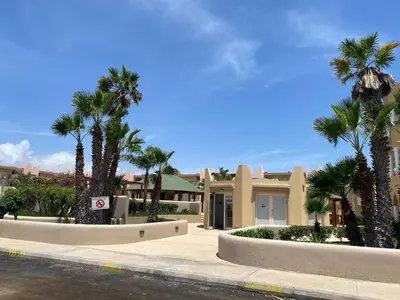 a row of palm trees in front of a house at Tropical Pool View - By Bobbywashere in Santa Maria