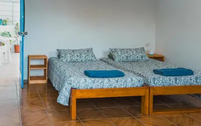 a bed in a room with blue pillows on it at Oiá Paúl in Paul