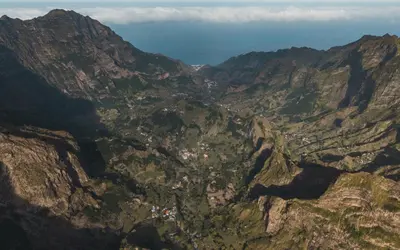 an aerial view of a mountain valley with houses at Oiá Paúl in Paul