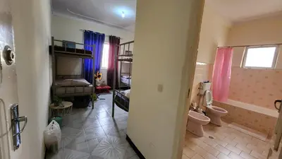 a room with a bathroom with a toilet and a sink at MEETING POINT HOSTEL-Praia Group Reservations in Praia