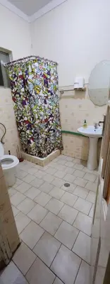 a bathroom with a shower and a toilet and a sink at MEETING POINT HOSTEL-Praia Group Reservations in Praia